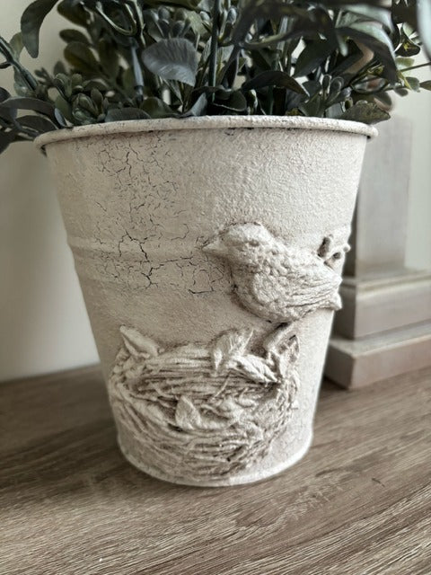 Metal pot with clay bird design and faux greenery