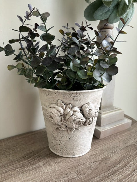 Metal pot with clay floral design and faux greenery
