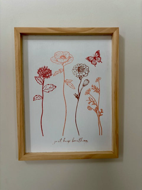 Framed artwork with red floral and butterfly illustration on a white background