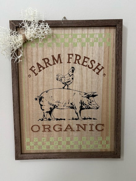 Decorative sign with 'Farm Fresh Organic' text and animal illustrations on a wooden background.