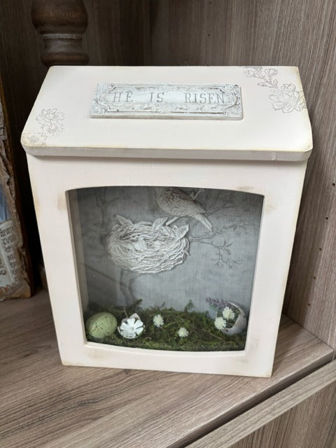 Decorative shadowbox with a bird's nest illustration 