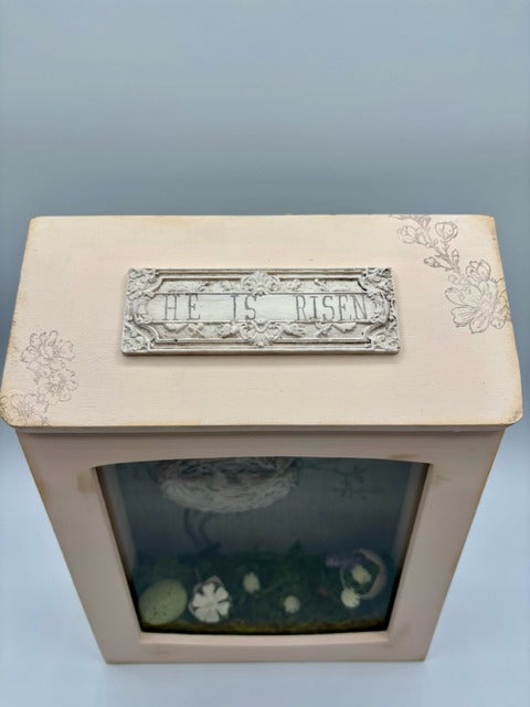 Decorative shadowbox with a bird's nest illustration 