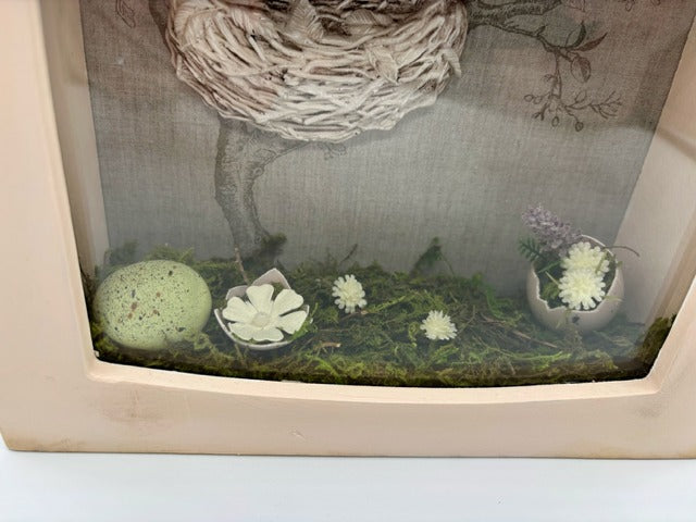 Decorative shadowbox with a bird's nest illustration 