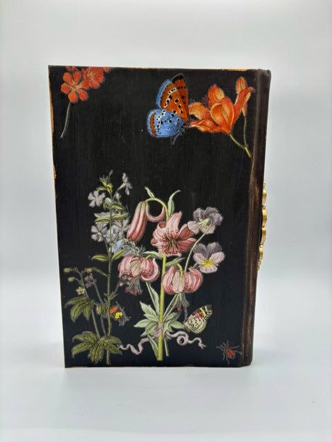 Decorative book with floral illustrations and a butterfly on a white background