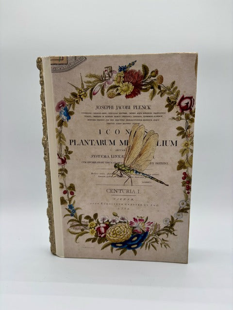 Decorative book cover with floral and botanical design on a white background
