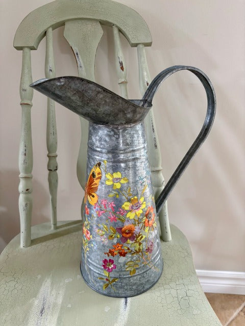 Decorative metal pitcher with floral design 