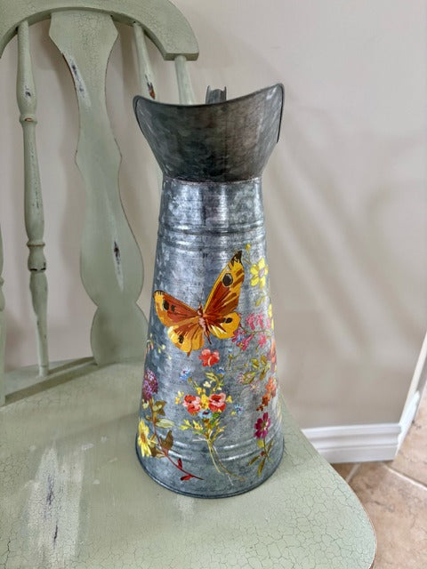 Decorative metal pitcher with floral design 
