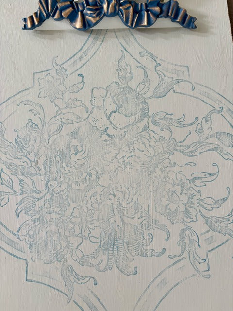 Decorative clipboard
 with intricate blue pattern on a white background