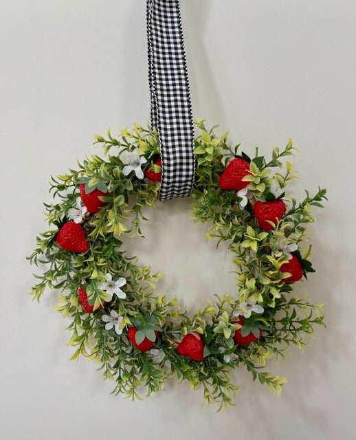 Decorative wreath with strawberries and a checkered ribbon