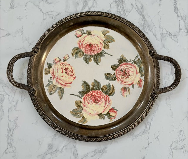 Decorative tray with floral design on a marble surface