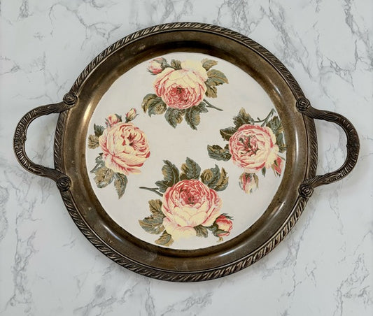 Decorative tray with floral design on a marble surface