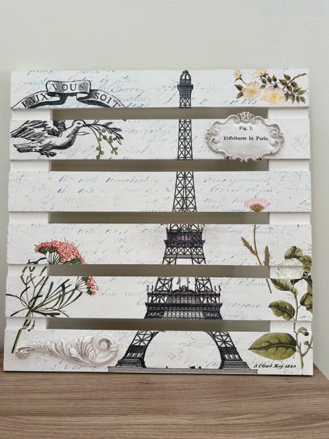 Decorative wall panel with Eiffel Tower and floral designs on a white background