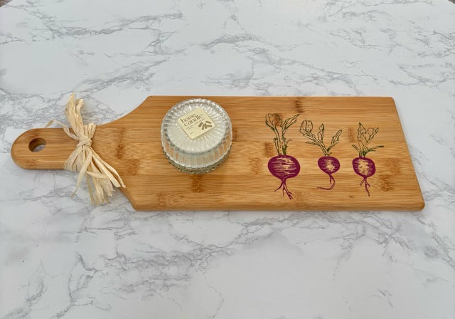 Bamboo cutting board with radish design on a marble surface