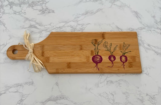 Bamboo cutting board with radish design on a marble surface