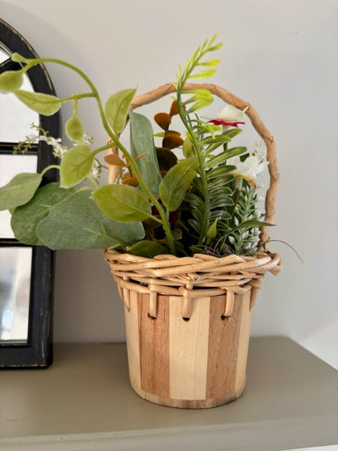Decorative basket with red raspberries and green leaves 