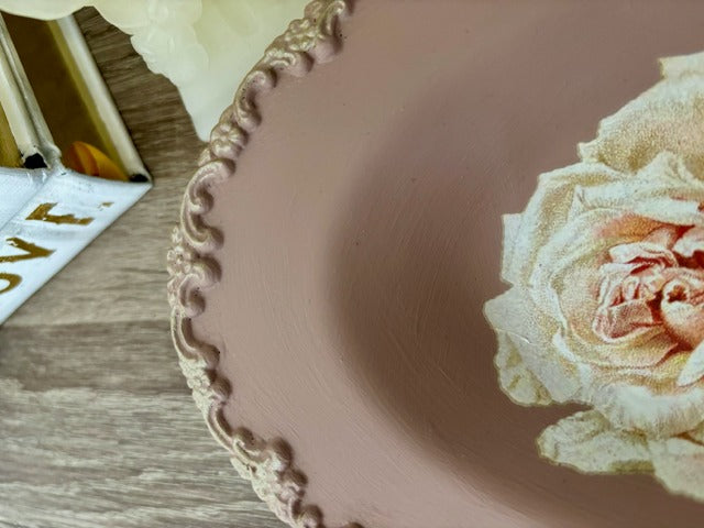 Decorative plate with floral design on a wooden surface