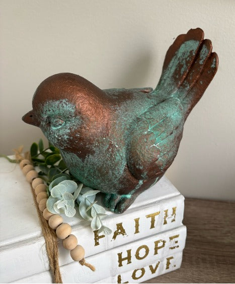 Bird figurine painted in bronze paint with green patina