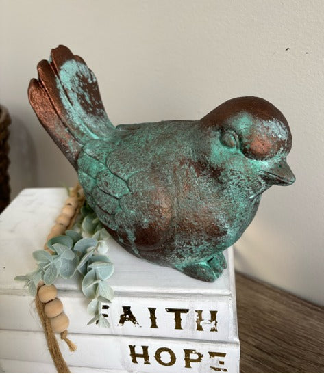 Bird figurine painted in bronze paint with green patina