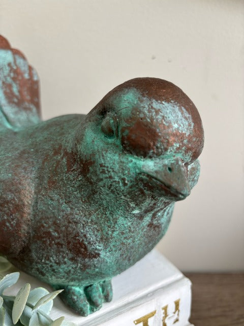 Bird figurine painted in bronze paint with green patina