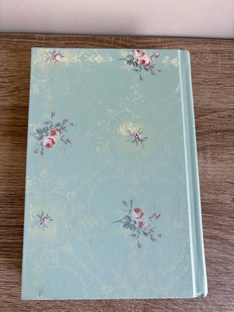 Floral-patterned book on a wooden surface