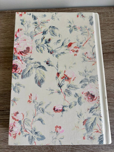 Floral-patterned book on a wooden surface
