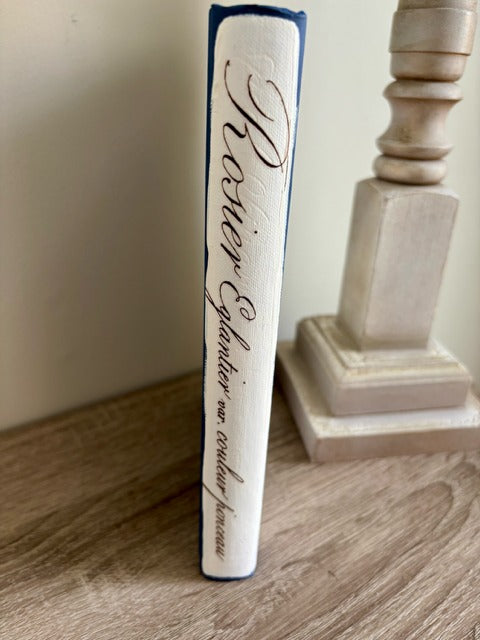 Decorative book with cursive text on a wooden surface