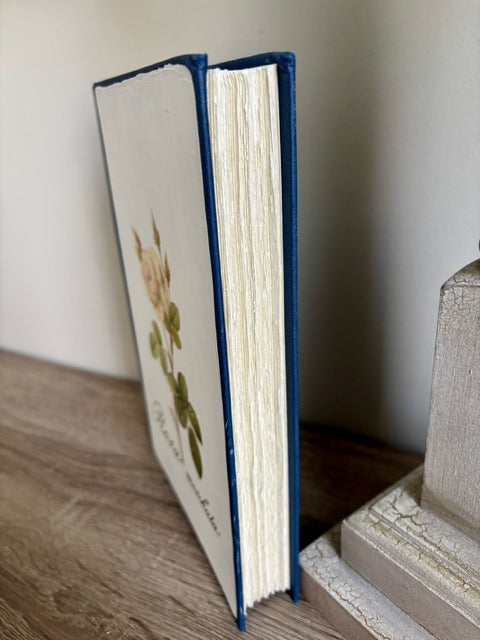 Open book with blue binding on a wooden surface