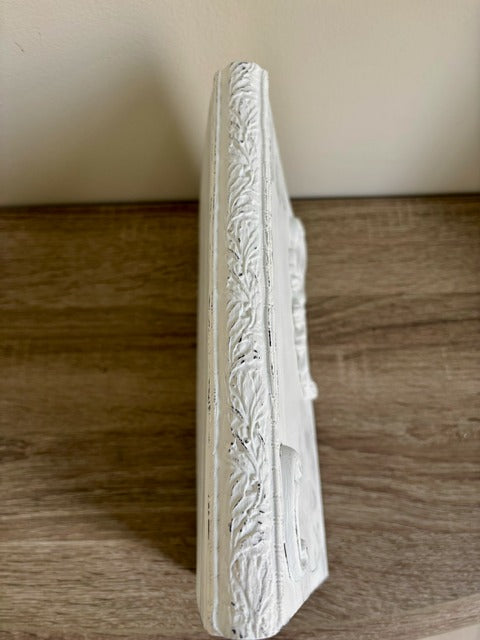 Decorative white molding on a book surface