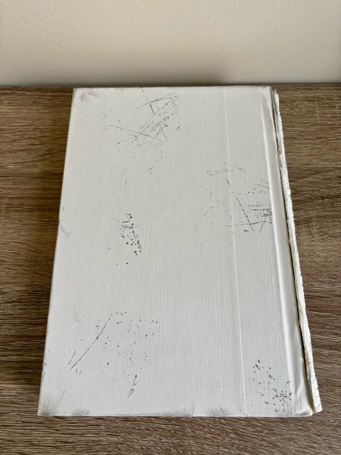 White textured book on a wooden surface