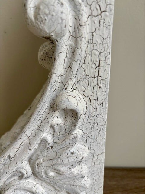 Close-up of a textured white decorative corbel