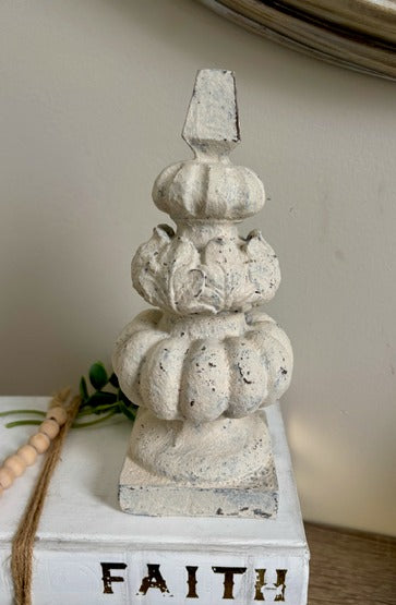 Decorative stone sculpture on a white block 