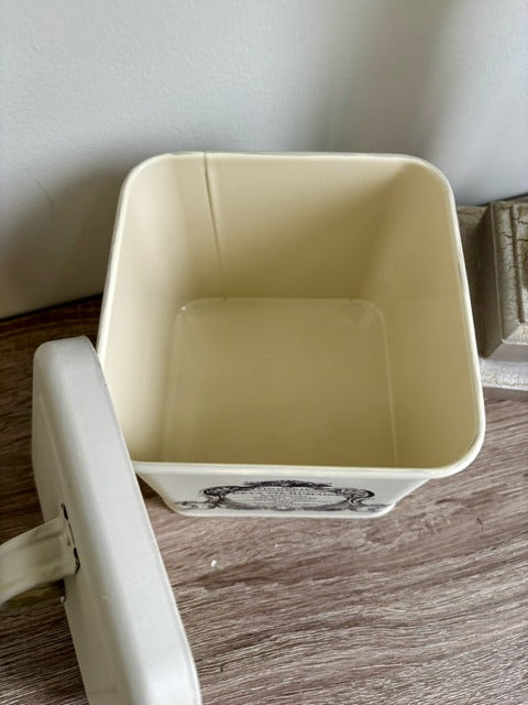 Beige canister with a label