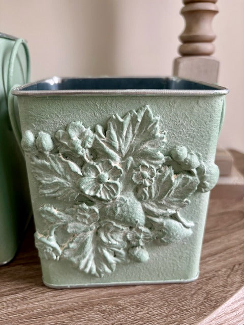 Decorative planter with clay floral design 
