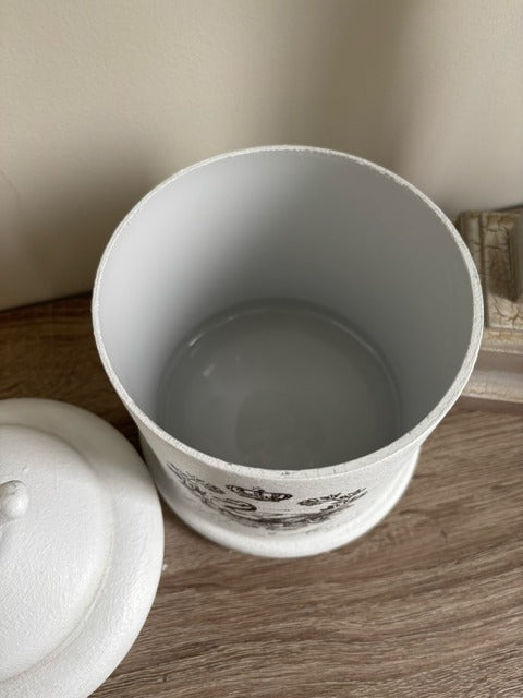 White ceramic container with lid on a wooden surface