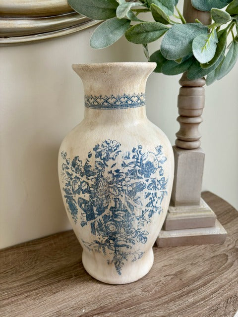 Decorative vase with blue floral patterns on a wooden surface