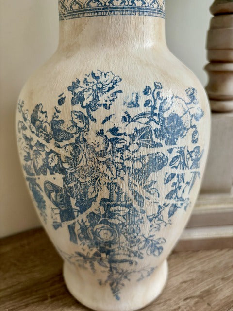 Decorative vase with blue floral patterns on a wooden surface