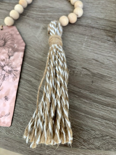 Tassel with braided design on a wooden surface