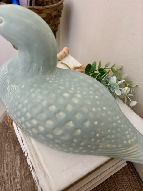 Decorative loon on a surface with a light background