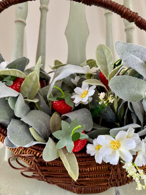 Decorative basket shaped like a swan with flowers and strawberries