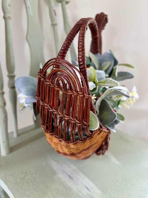 Decorative basket shaped like a swan with flowers and strawberries