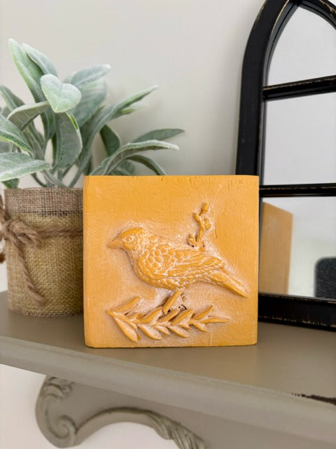 Wood block with clay bird