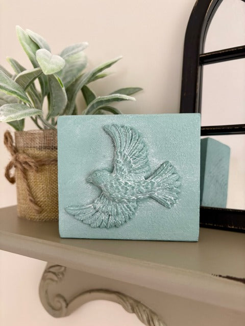 Wood block with clay bird