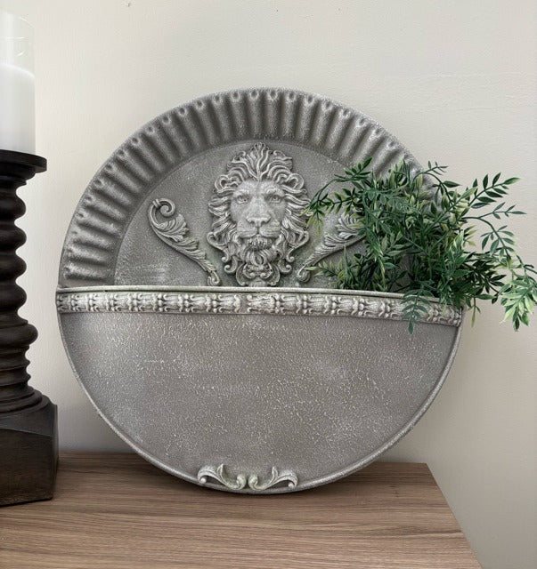 Decorative wall planter with lion design on a wooden surface