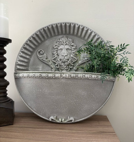 Decorative wall planter with lion design on a wooden surface