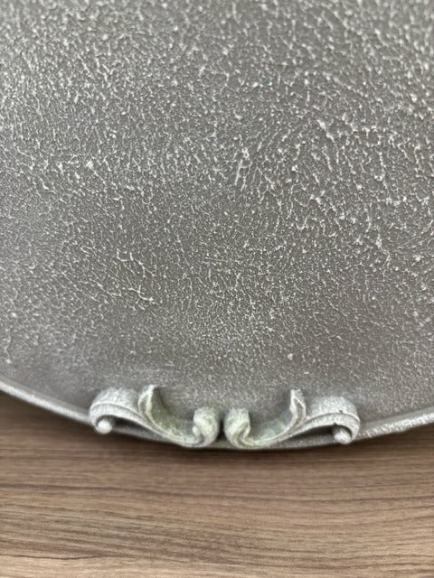 Close-up of a textured metallic object on a wooden surface