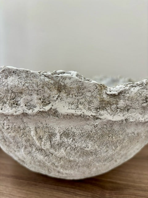 Textured  bowl on a wooden surface with a neutral background