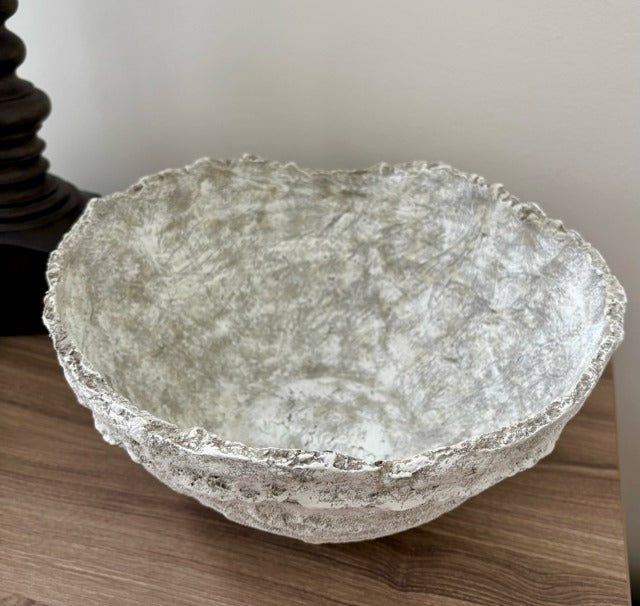 Textured  bowl on a wooden surface with a neutral background